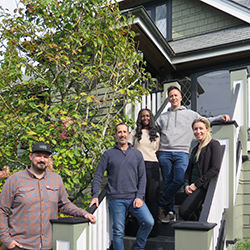 A group of five people standing in front of a Heritage House in Richmond, BC