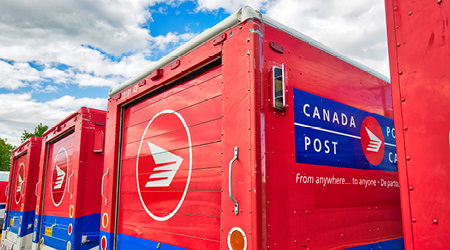 Image of Canada post trucks parked