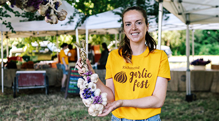 Garlic Fest volunteer showing braided garlic