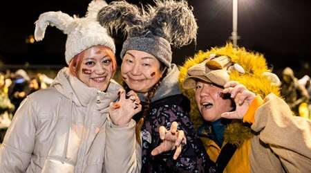 Three young people with face paint attending Halloween Fireworks event