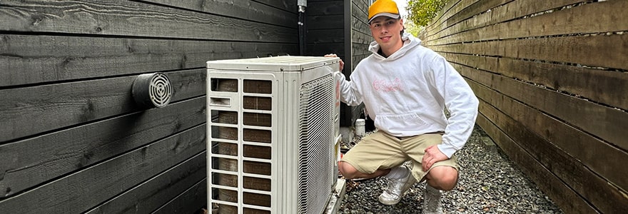 Homeowner showcasing their new heat pump installed beside their house