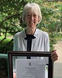A photo of Christine McGilvray with her Heritage Award
