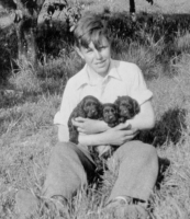 Ian Myron with Puppies at Home, 1938