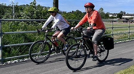 Two people riding their bikes on the Railway Greenbelt
