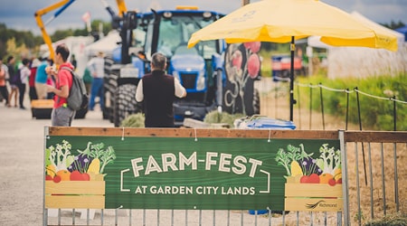 View of Farm Fest banner on a fence at the event