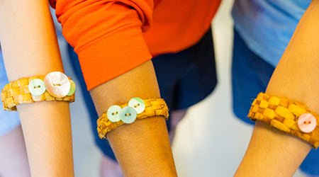 A group of people wearing woven bracelets