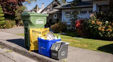 View of correctly sorted recycling bins in front of a home